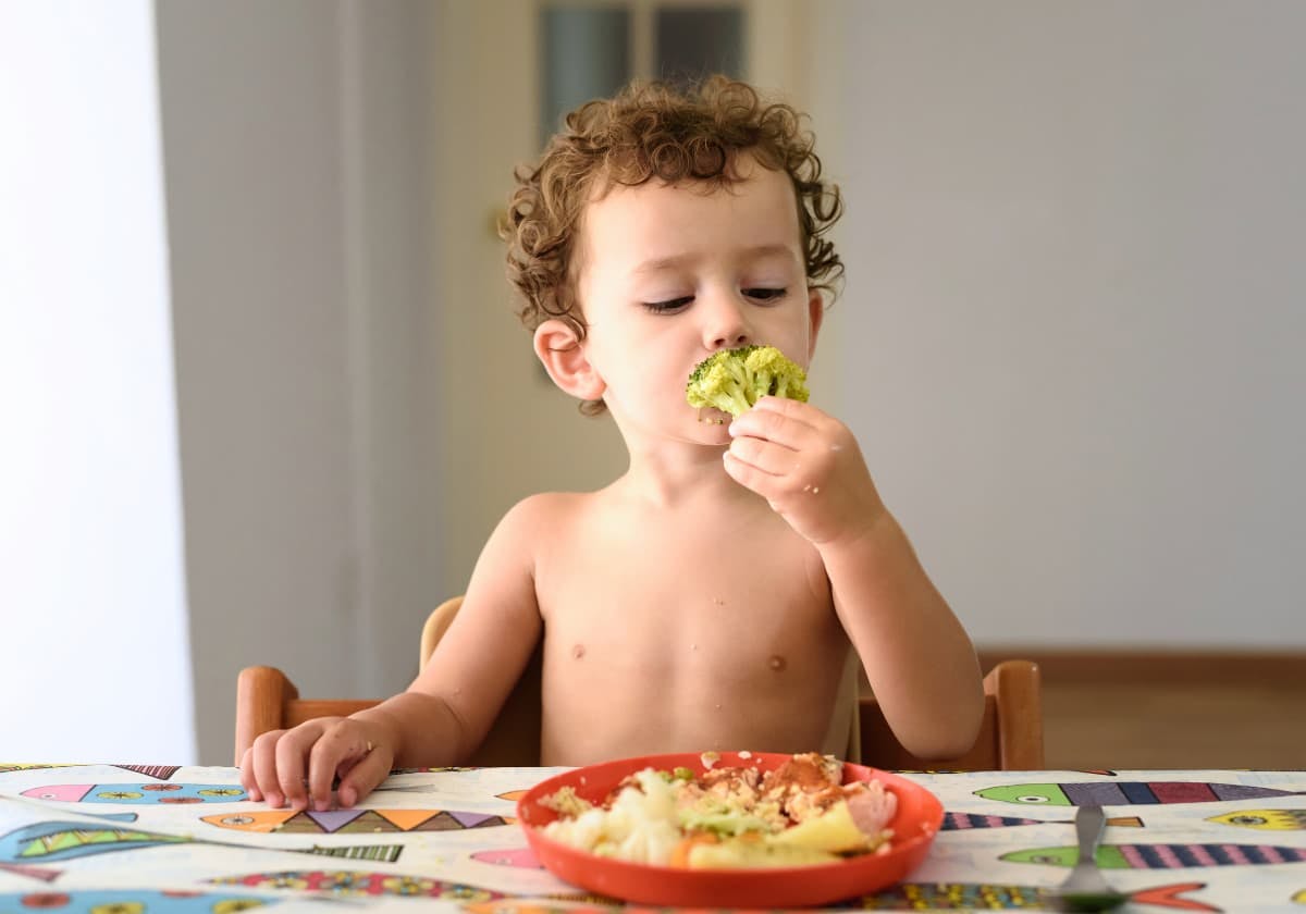 barn som sitter vid bordet och äter