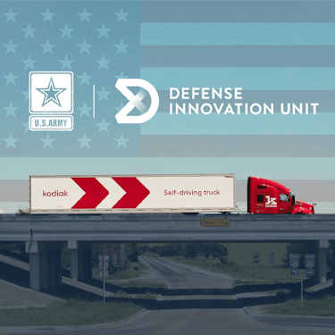 Image of a Kodiak truck on a highway with US Army and Defense Innovation Unit logos