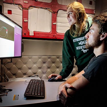 Two Kodiak employees looking at a computer