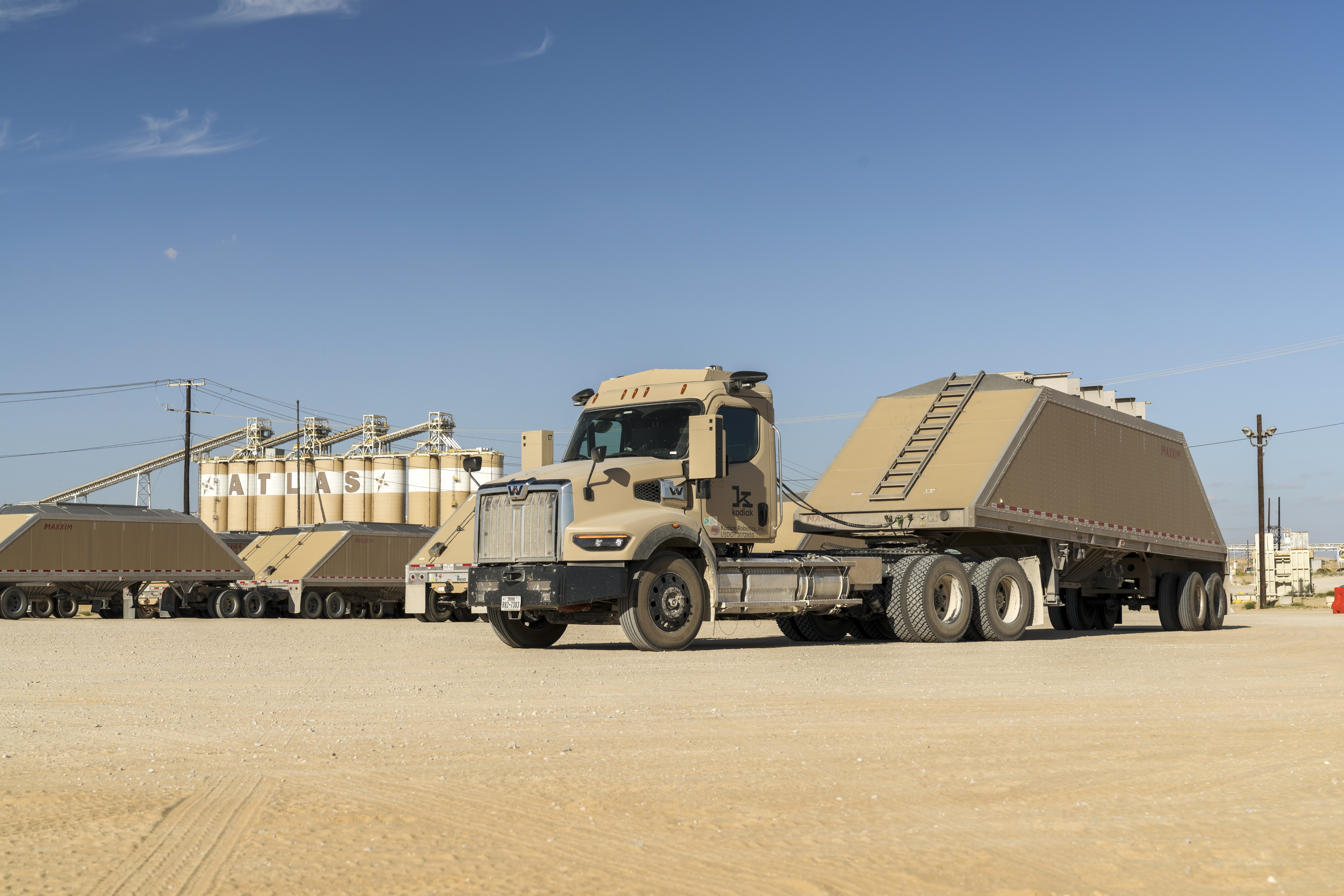 Silos with lettering spelling Atlas with a kodiak driver-powered truck