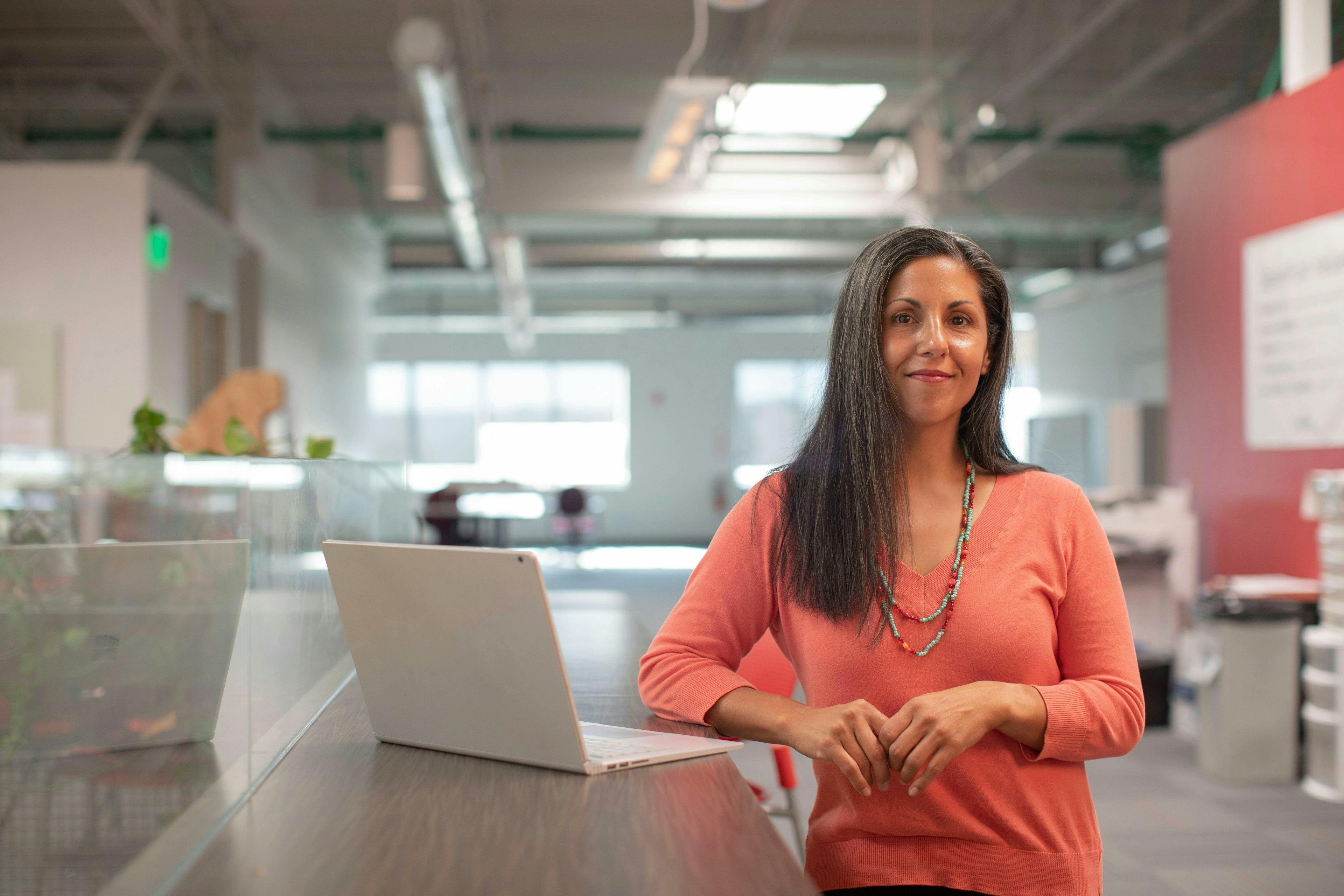 Woman posing by computer