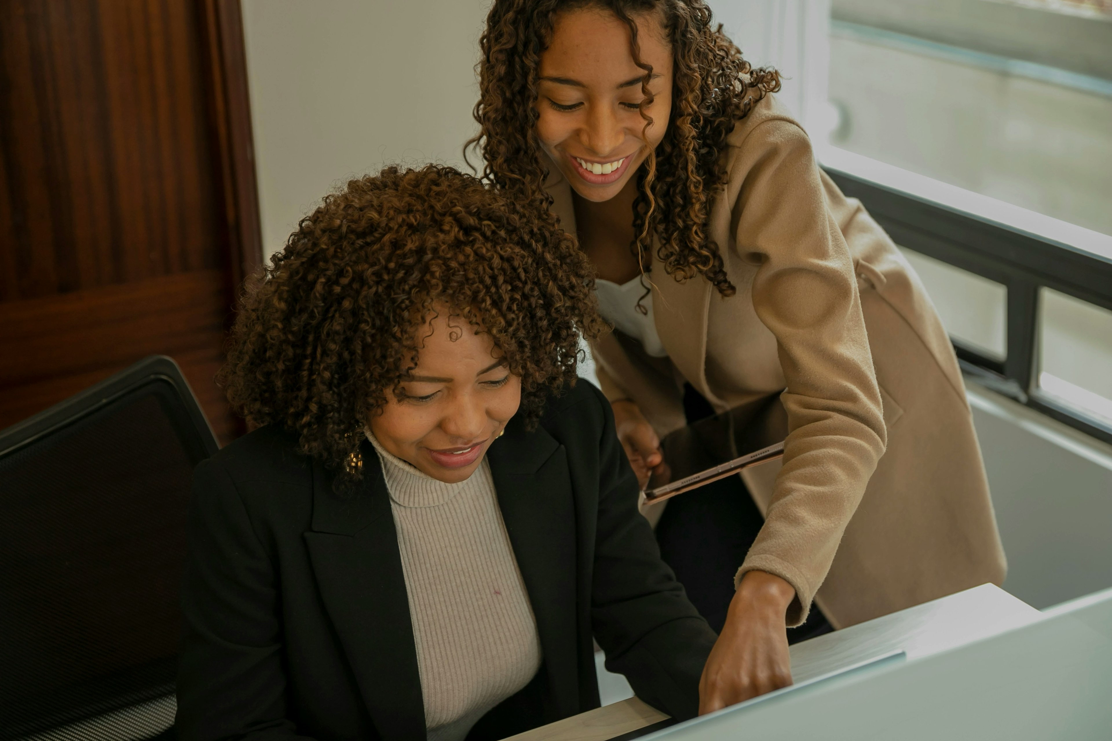 Two women working on a computer