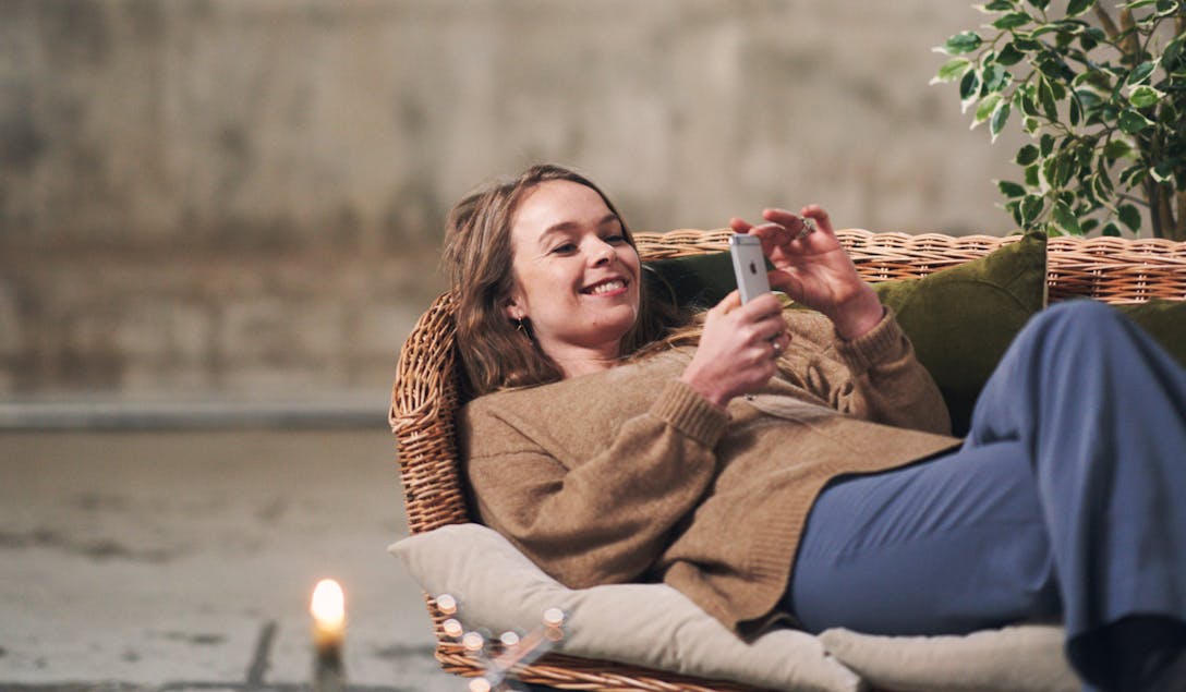 Woman using a smartphone on a couch