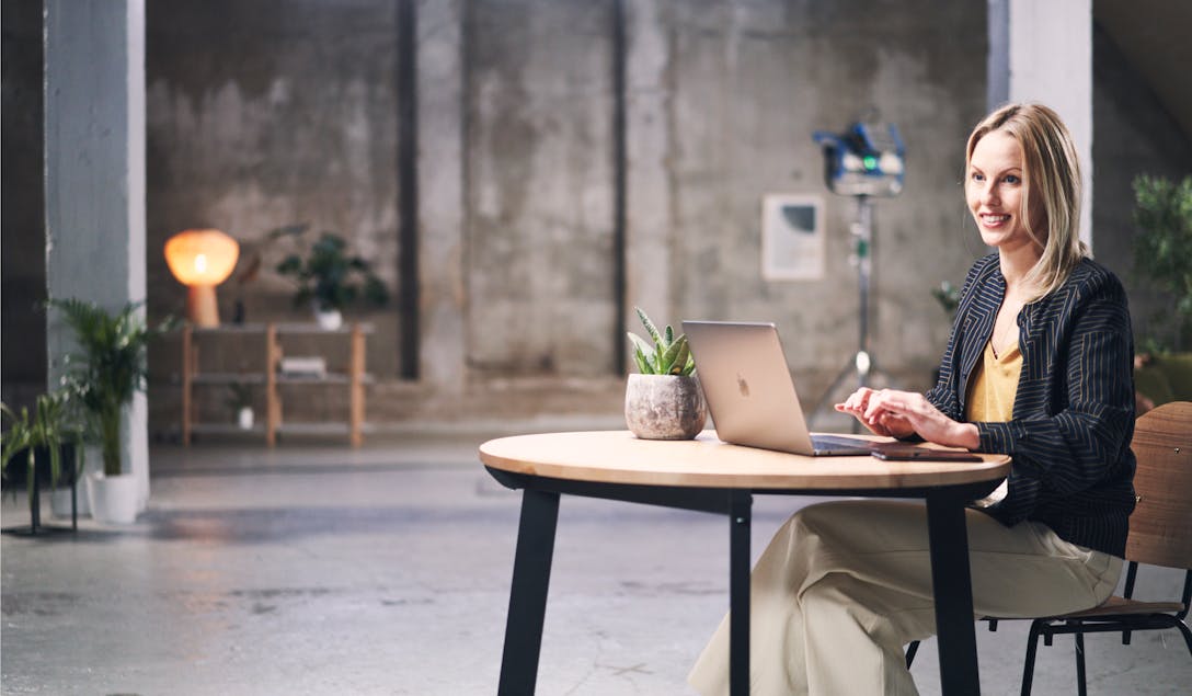 Woman sitting at a desk with a laptop computer