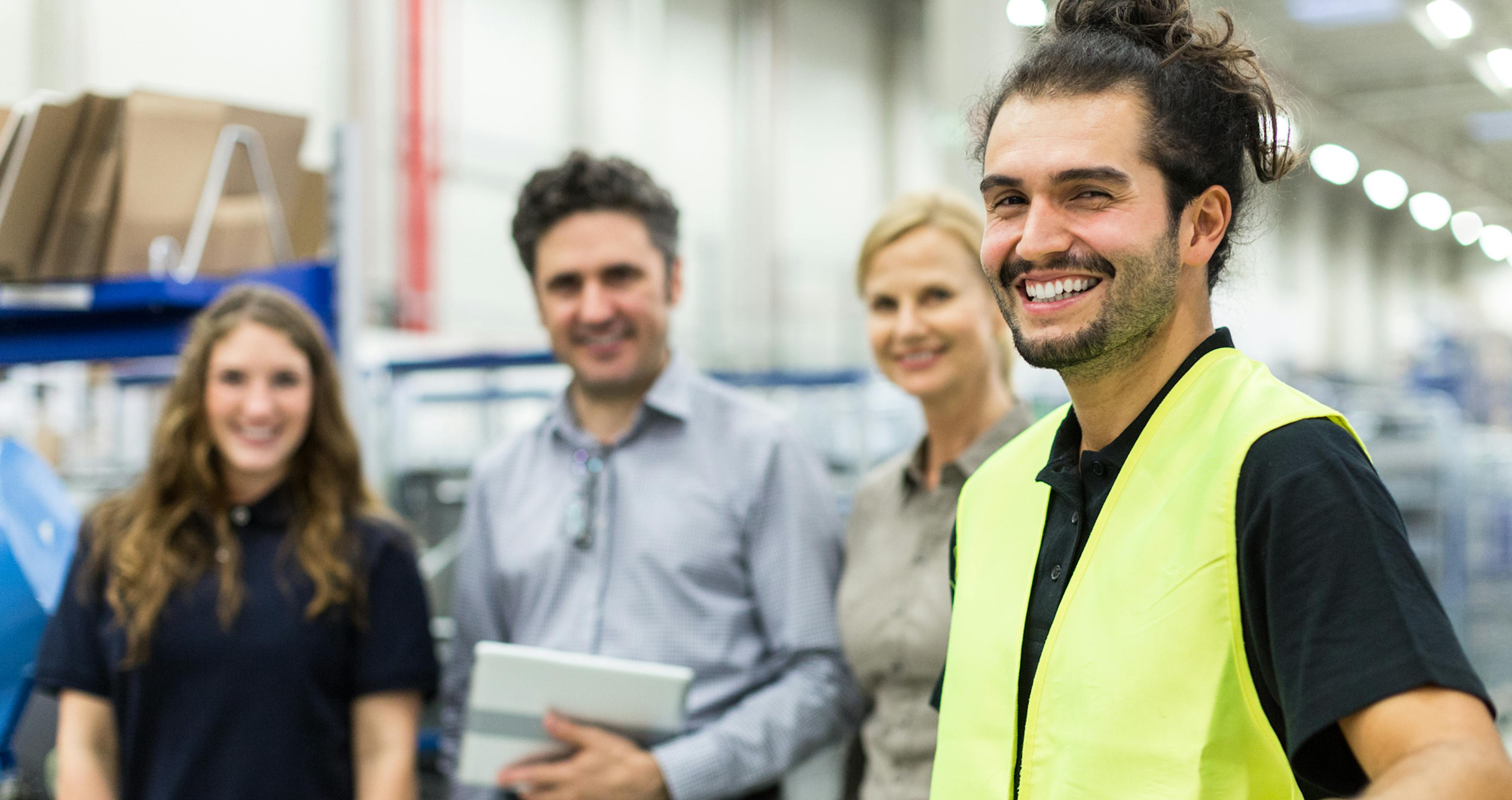 grupp-inom-industri-tittar-in-i-kameran-leende-3