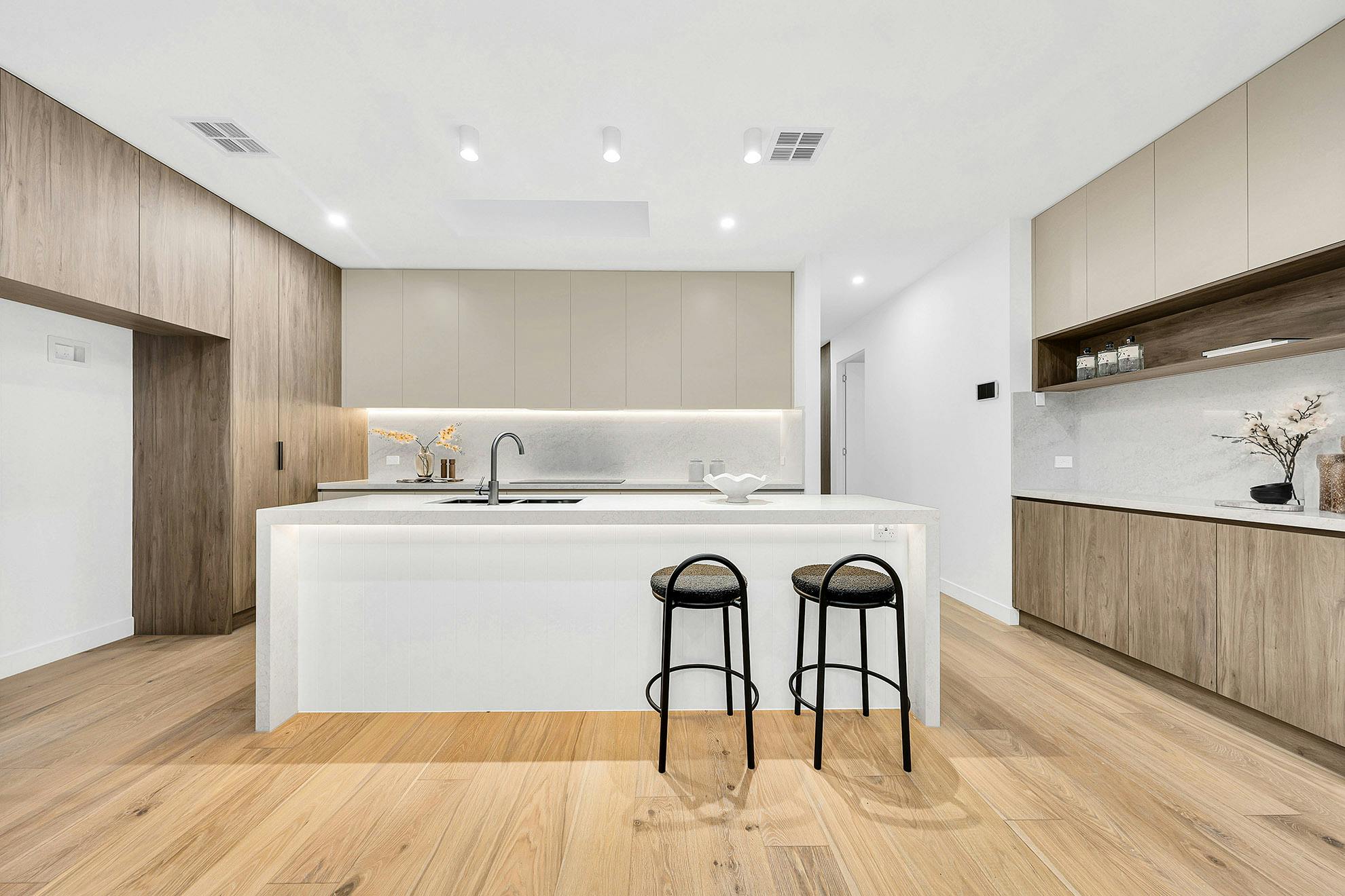Open kitchen design with 2 bar stools