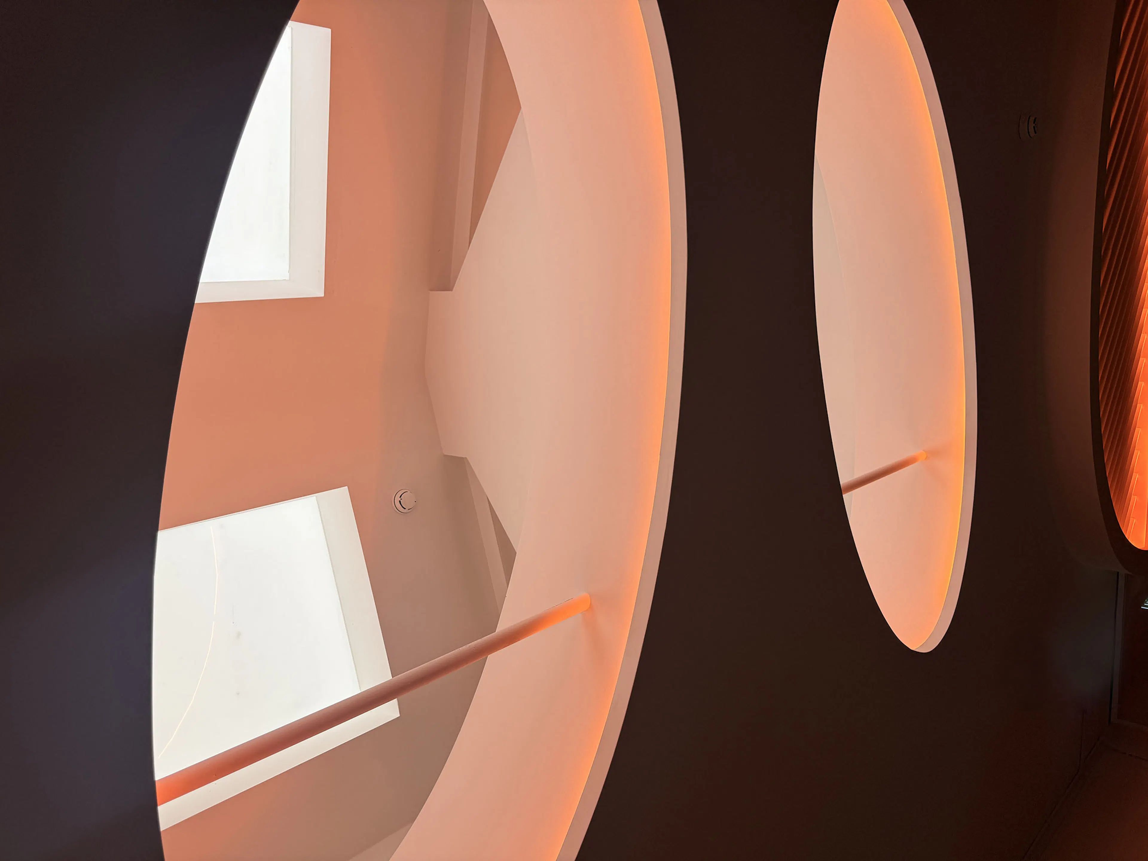 Architectural ceiling feature with circular cutouts and custom orange warm ambient LED lighting at Max Bar & Restaurant Hardware Lane