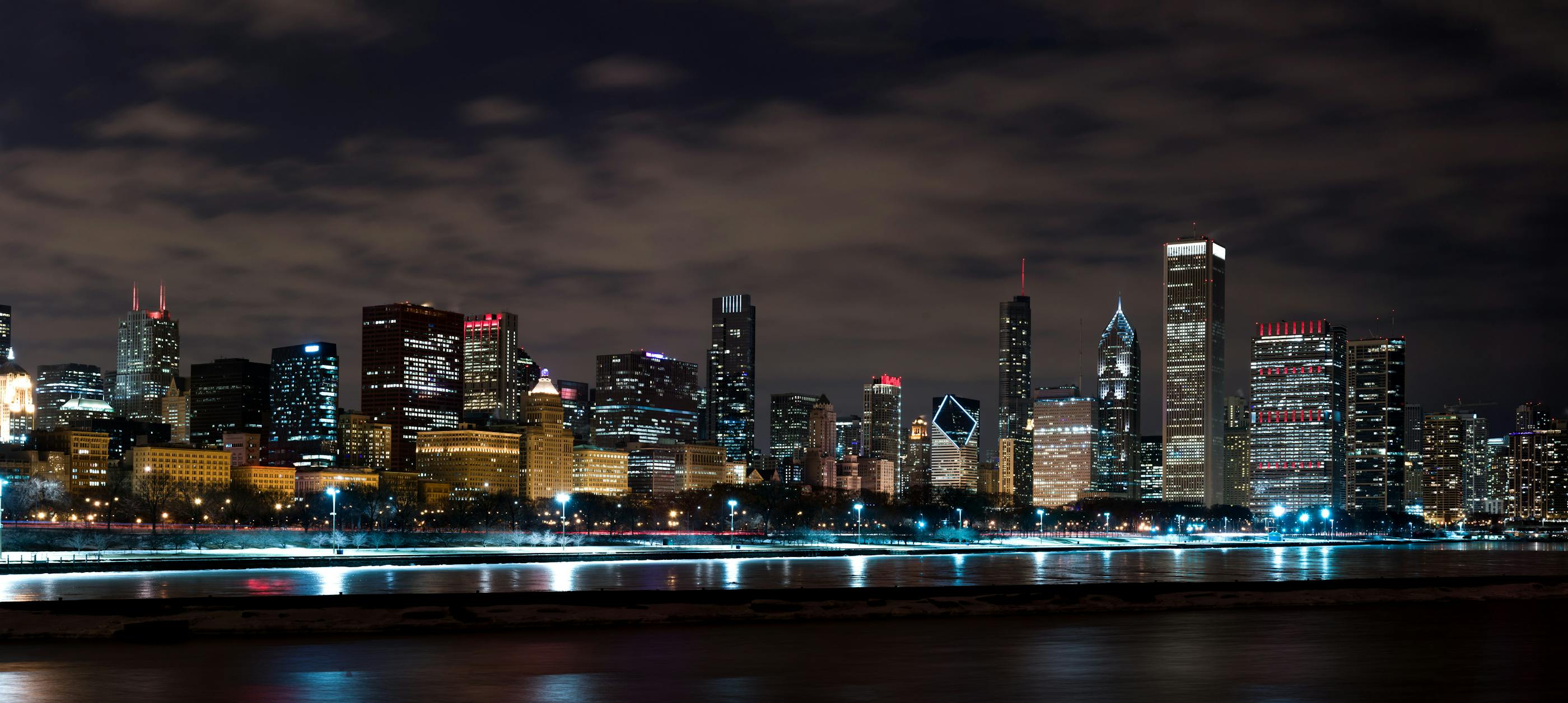 Wide Skyline of Chicago at Night with water in foreground