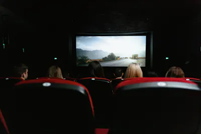 People watching movie in cinema hall pic