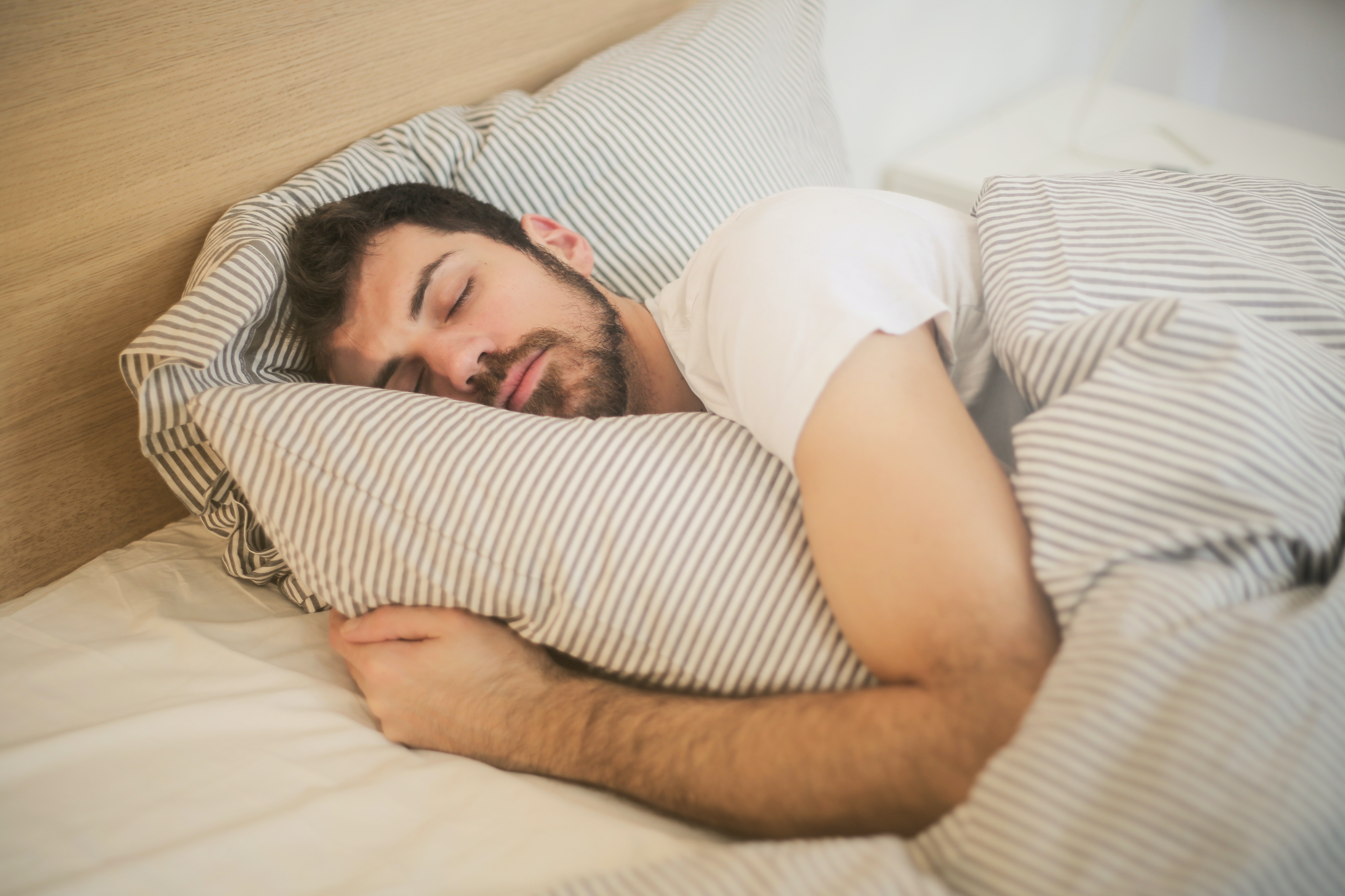 Image of a man sleeping comfortably in AC at night