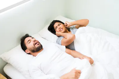 Women irritated with man snoring at night picture