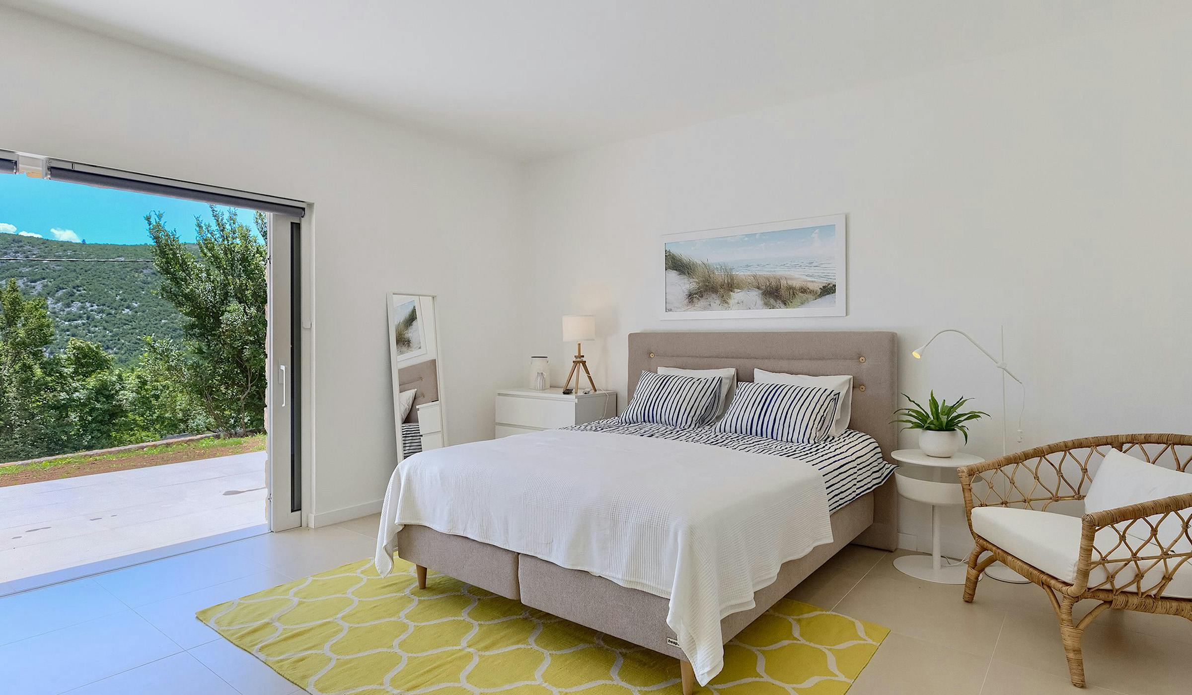 Relaxing bedroom in a villa with a beautiful poolside view.