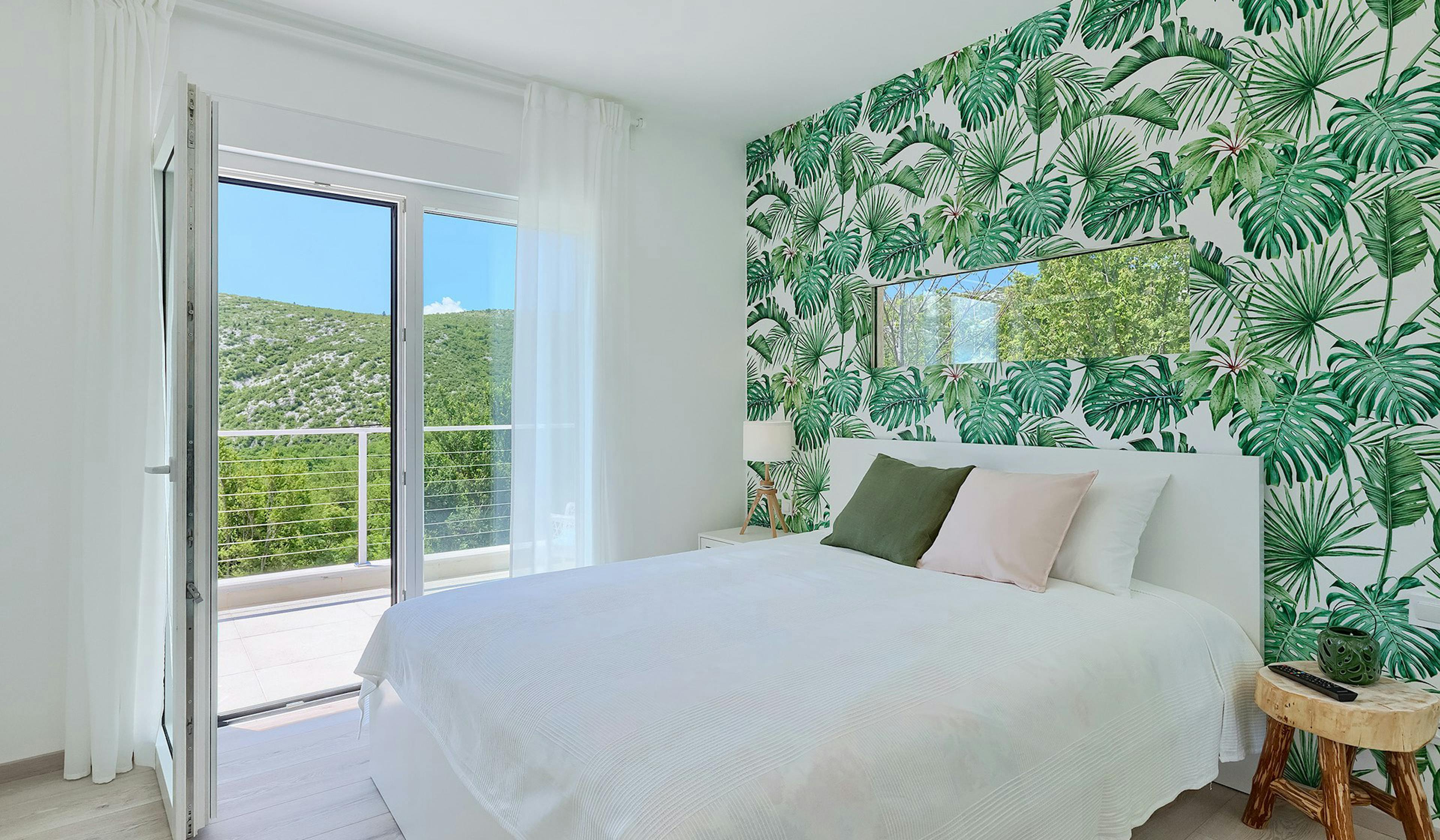 Tranquil villa bedroom with a private pool vista.