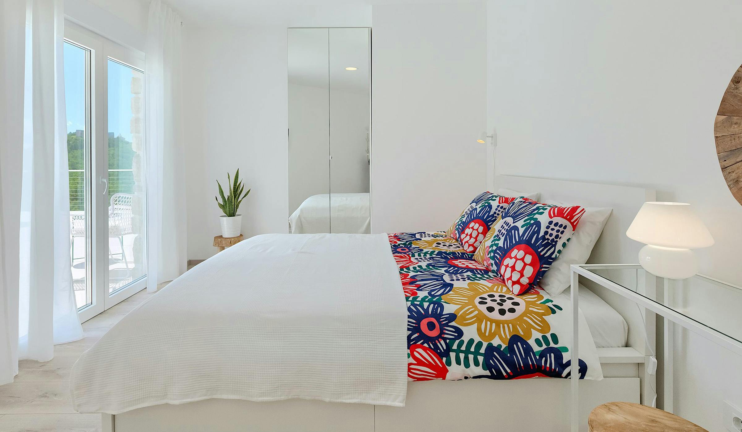 Elegant villa bedroom with direct pool access.