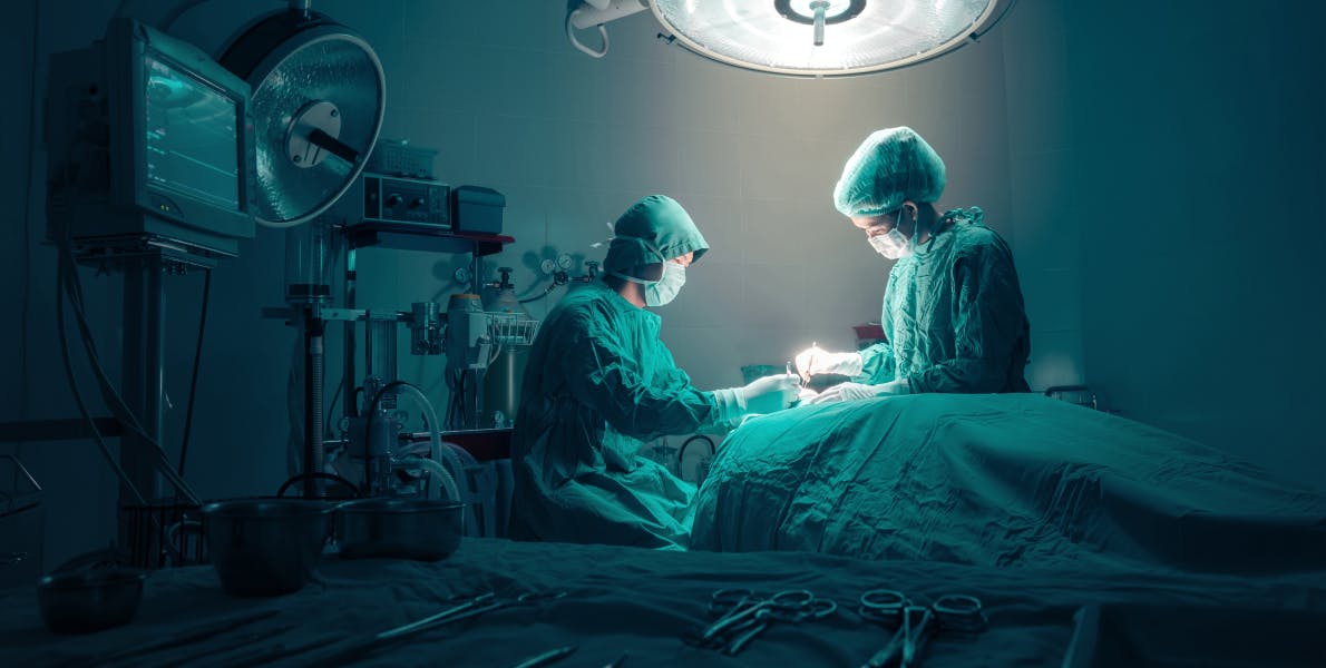 Doctors performing surgery on a patient