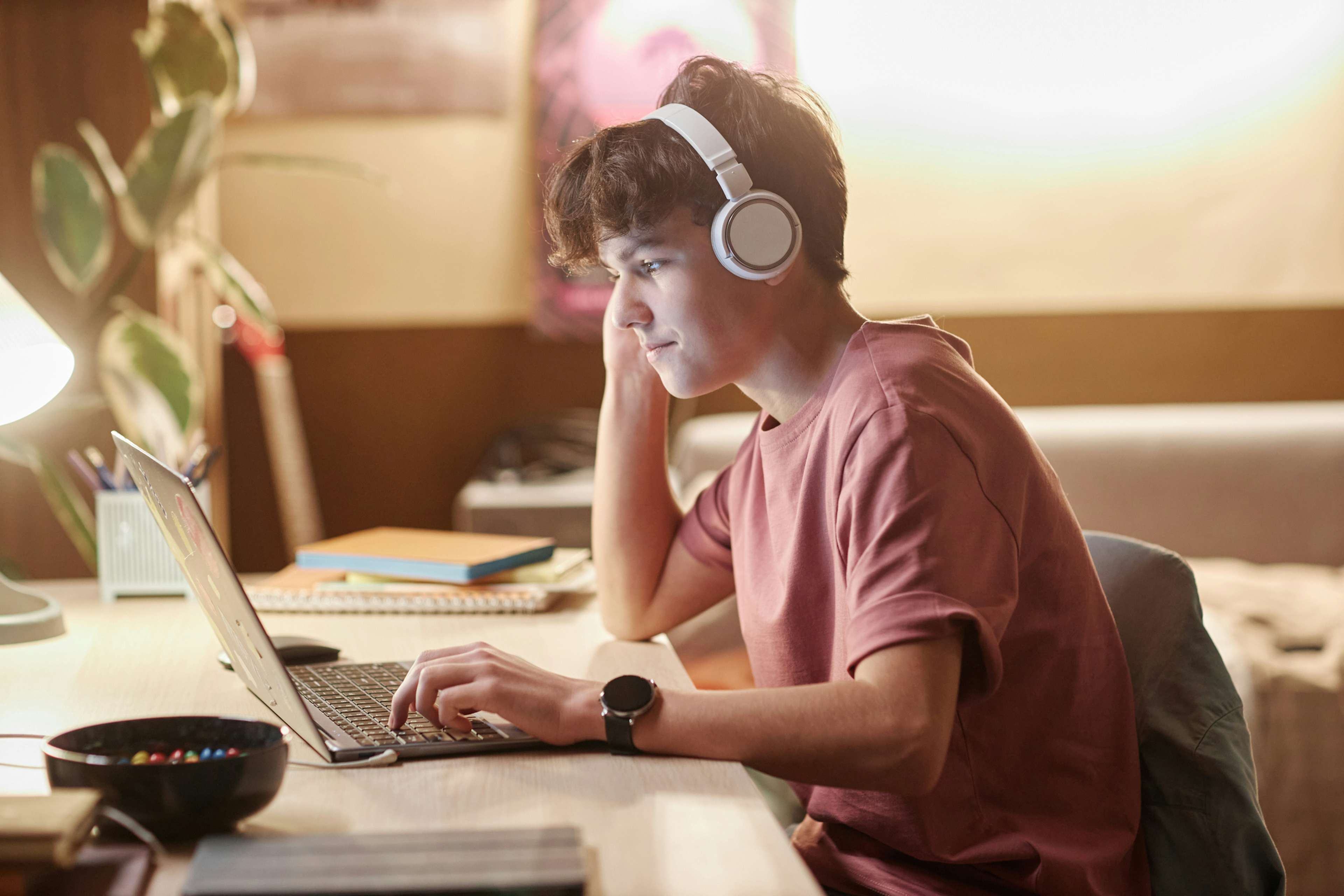 Boy sitting at computer applying to a Notre Dame pre-college course