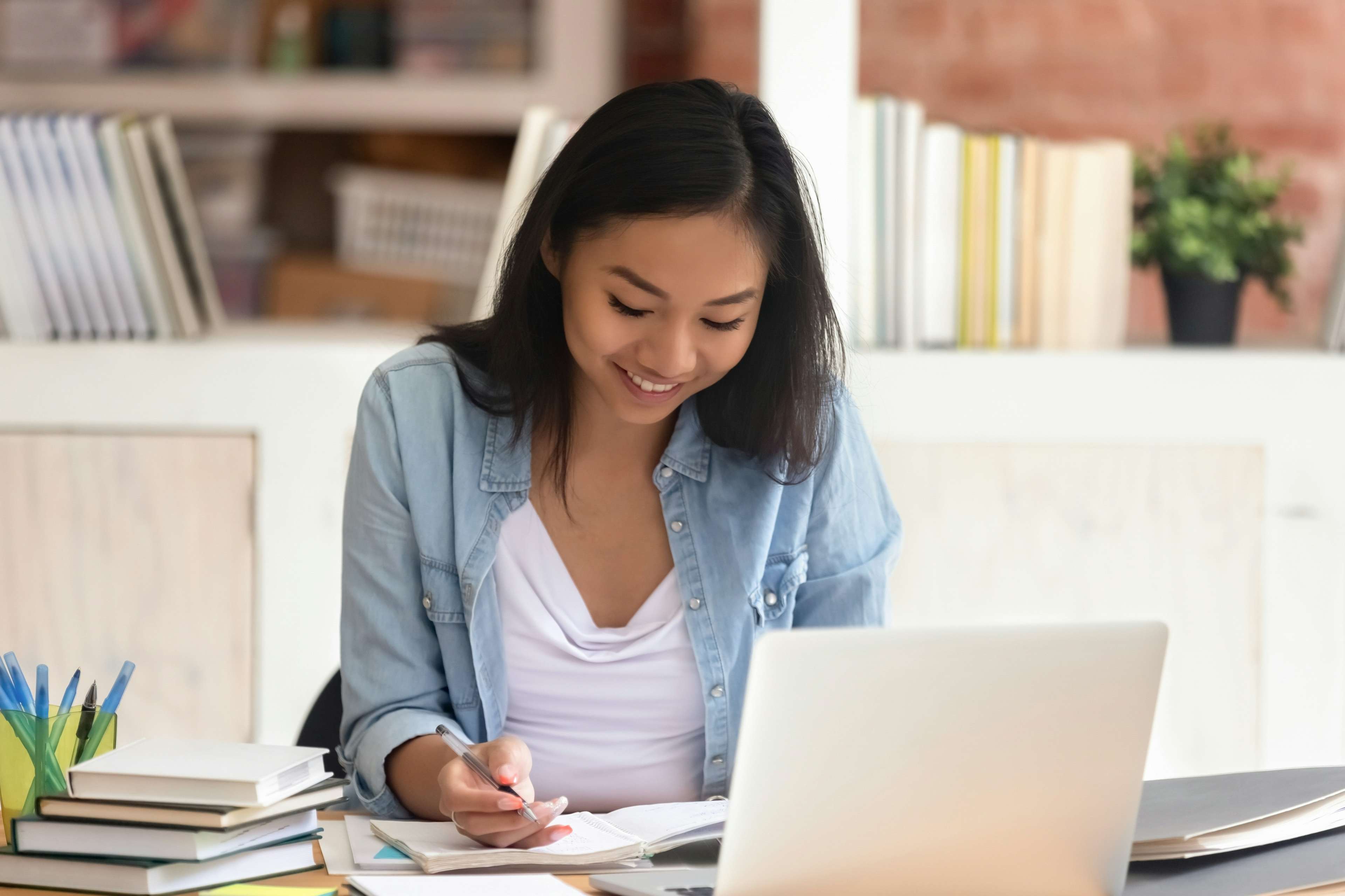 Student sitting in front of computer completing a Notre Dame pre-college course