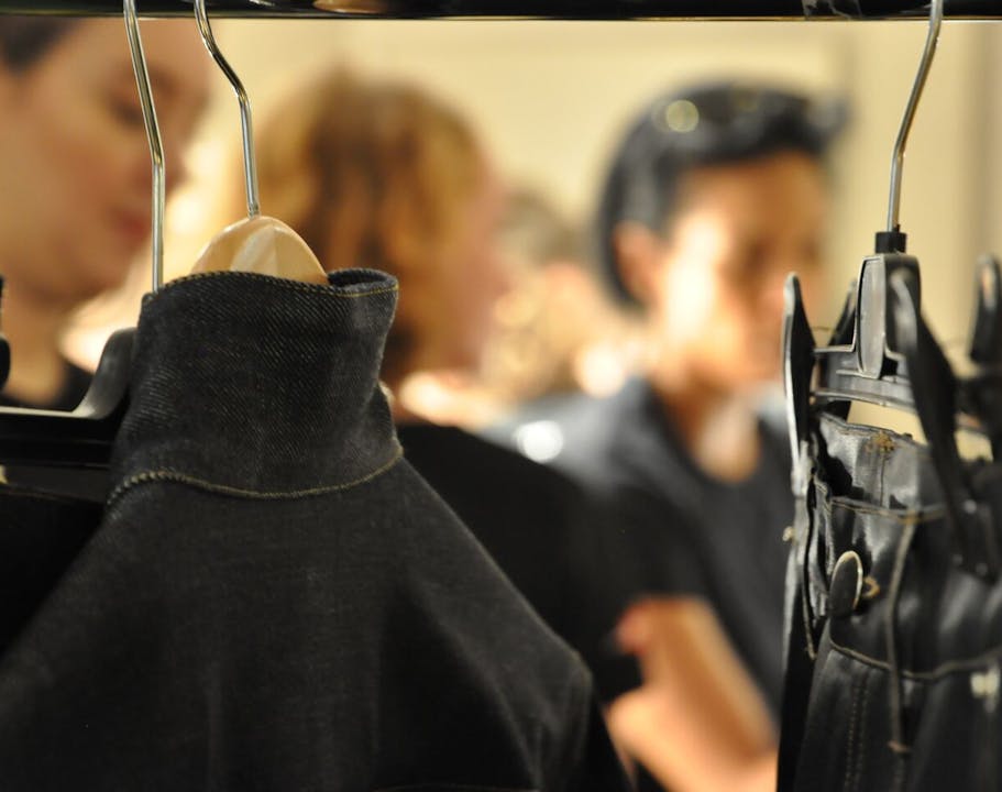 Rack of clothing that is behind-the-scenes at a fashion show
