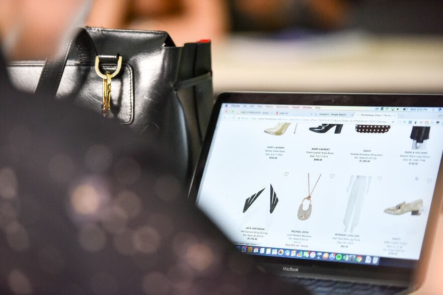 Laptop screen showing products from a luxury fashion brand