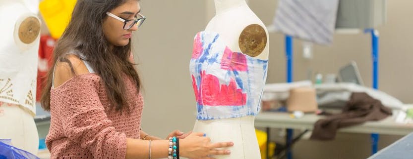 Woman draping eco-friendly fabric on a dress form