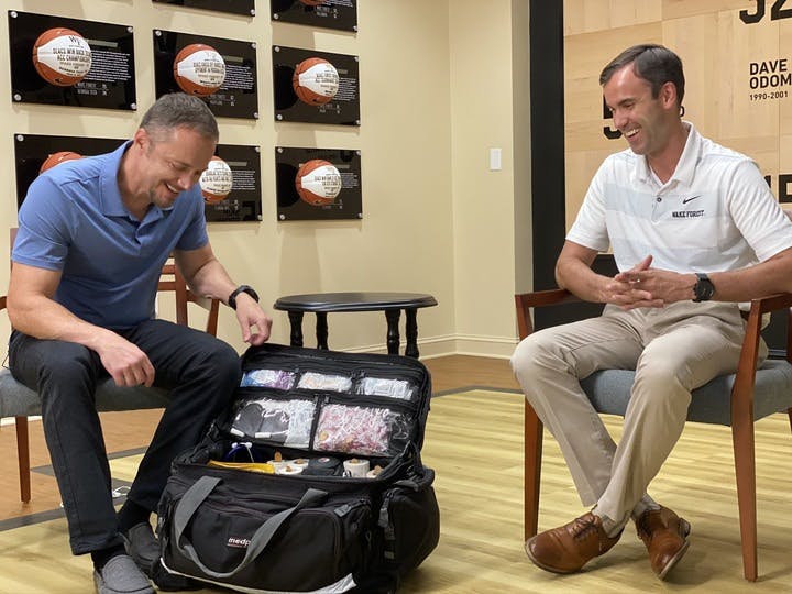 Dr. Waterman and guest viewing the contents of a sports medicine bag
