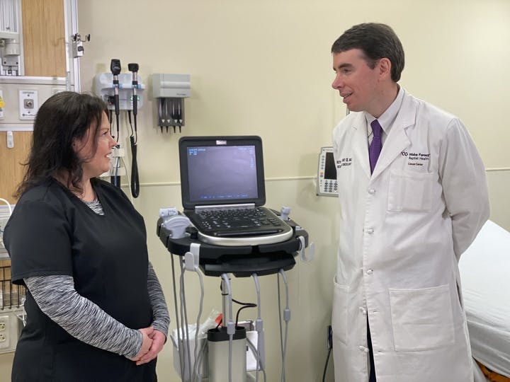 Decorative: Dr. Roy Strowd speaking with a nurse