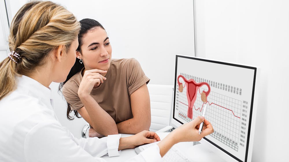 Doctor and patient viewing ovarian test results on a computer