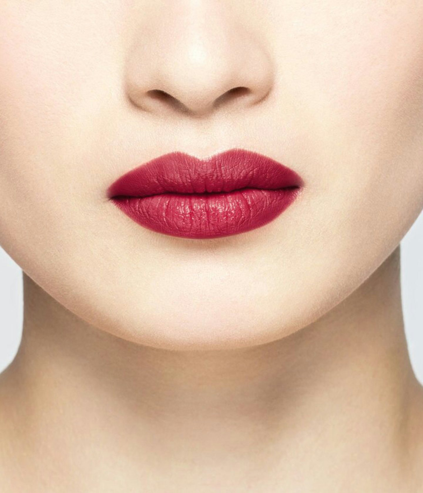 La bouche rouge Le Rouge Anja lipstick shade on the lips of an Asian model
