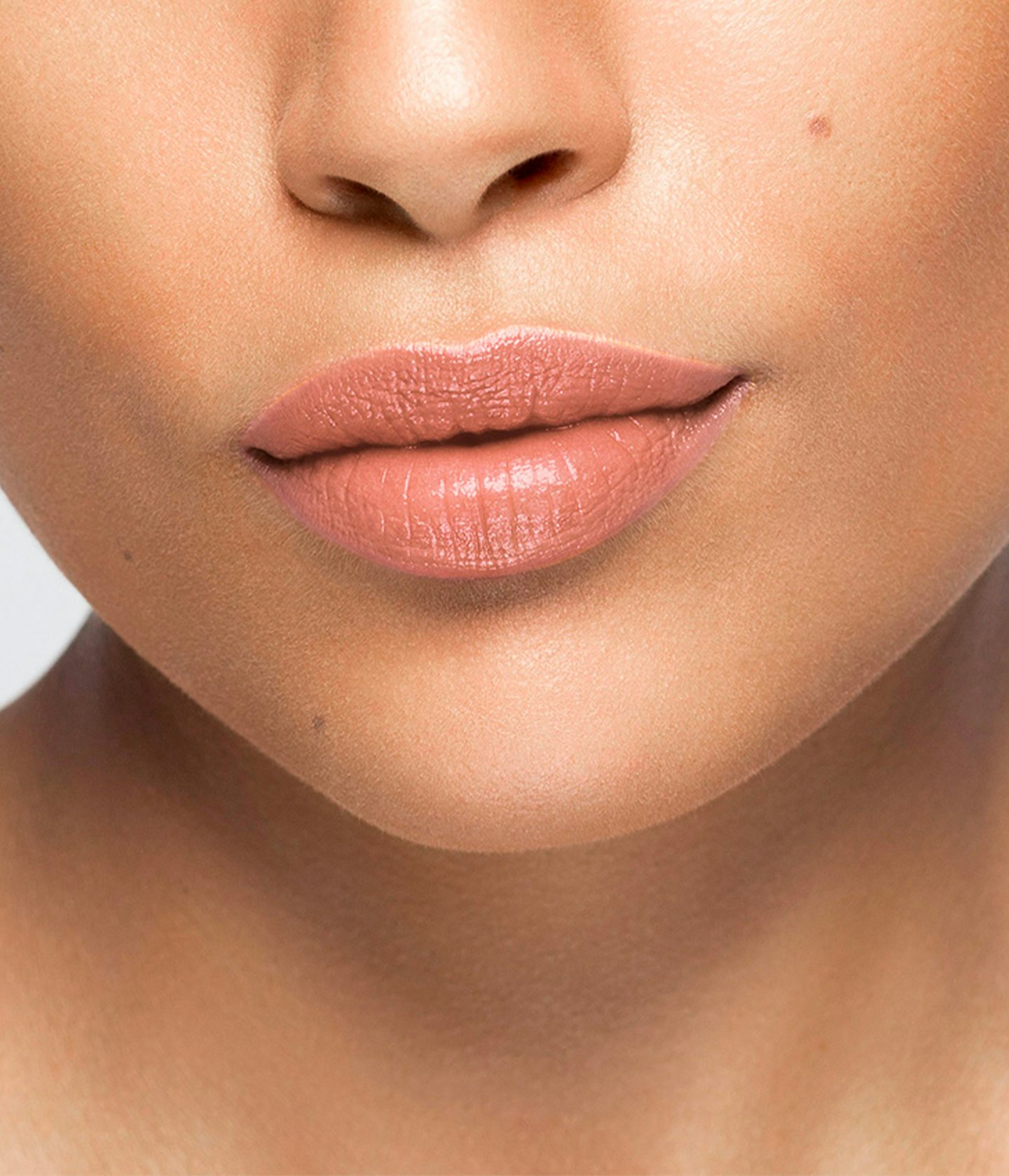La bouche rouge Le Nude Elsa lipstick shade on the lips of an medium skin model