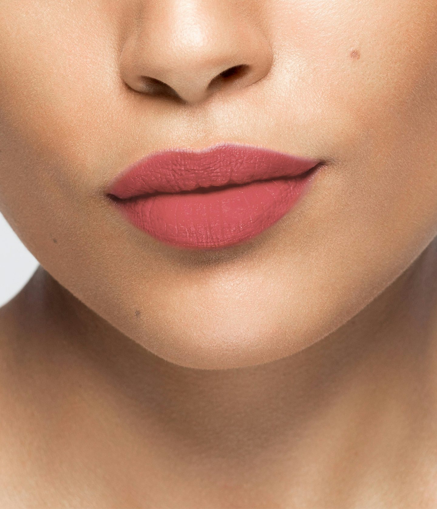 La bouche rouge Cherry Pink lipstick shade on the lips of a medium skin model