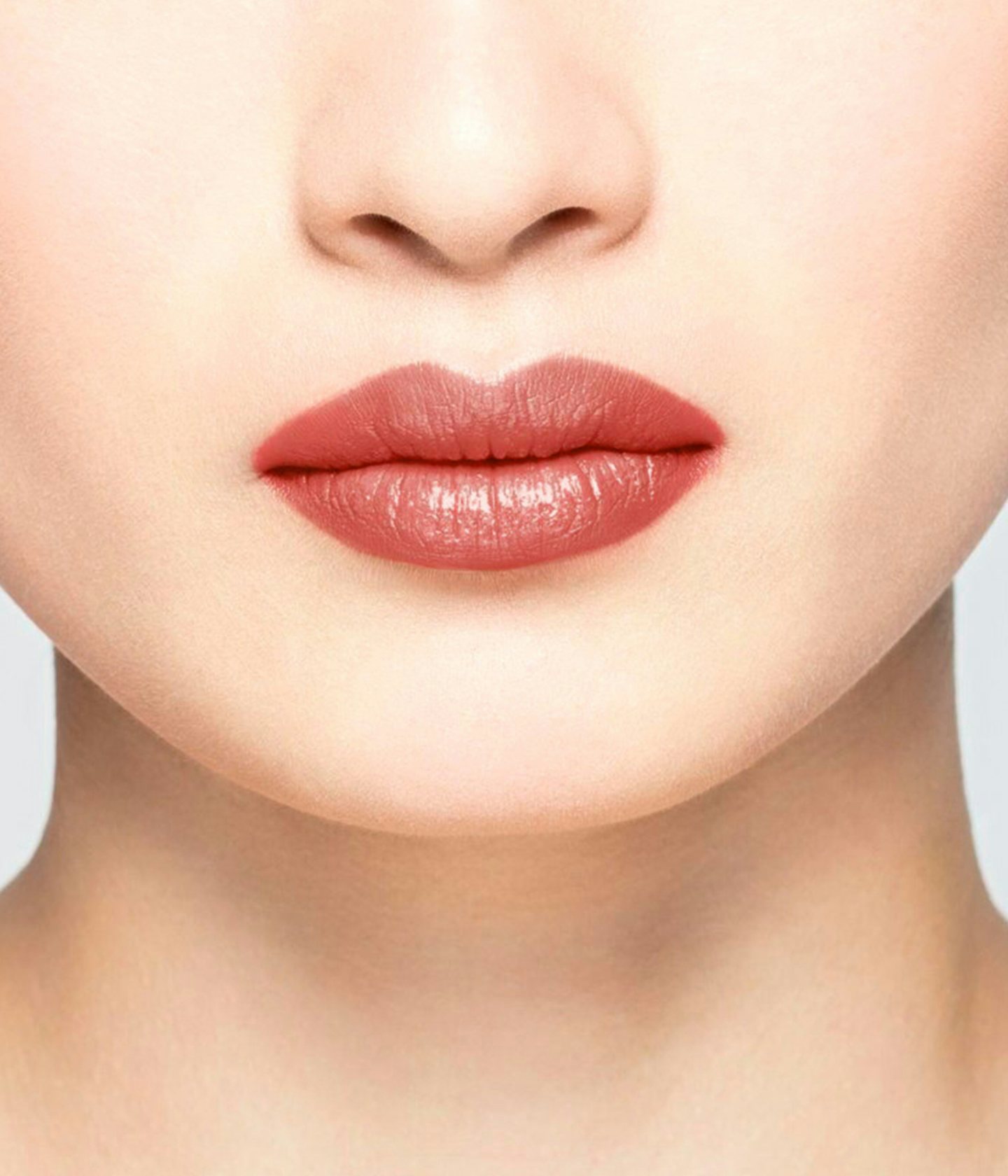 La bouche rouge Red balm shade on the lips of an Asian model