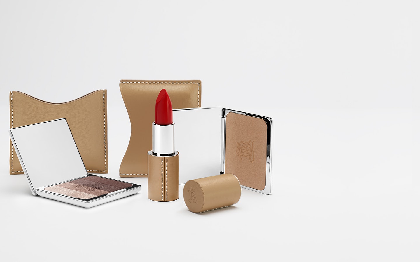 La bouche rouge lipstick, Les Ombres Aral eyeshadow and La Terre bronzer in camel fine leather cases