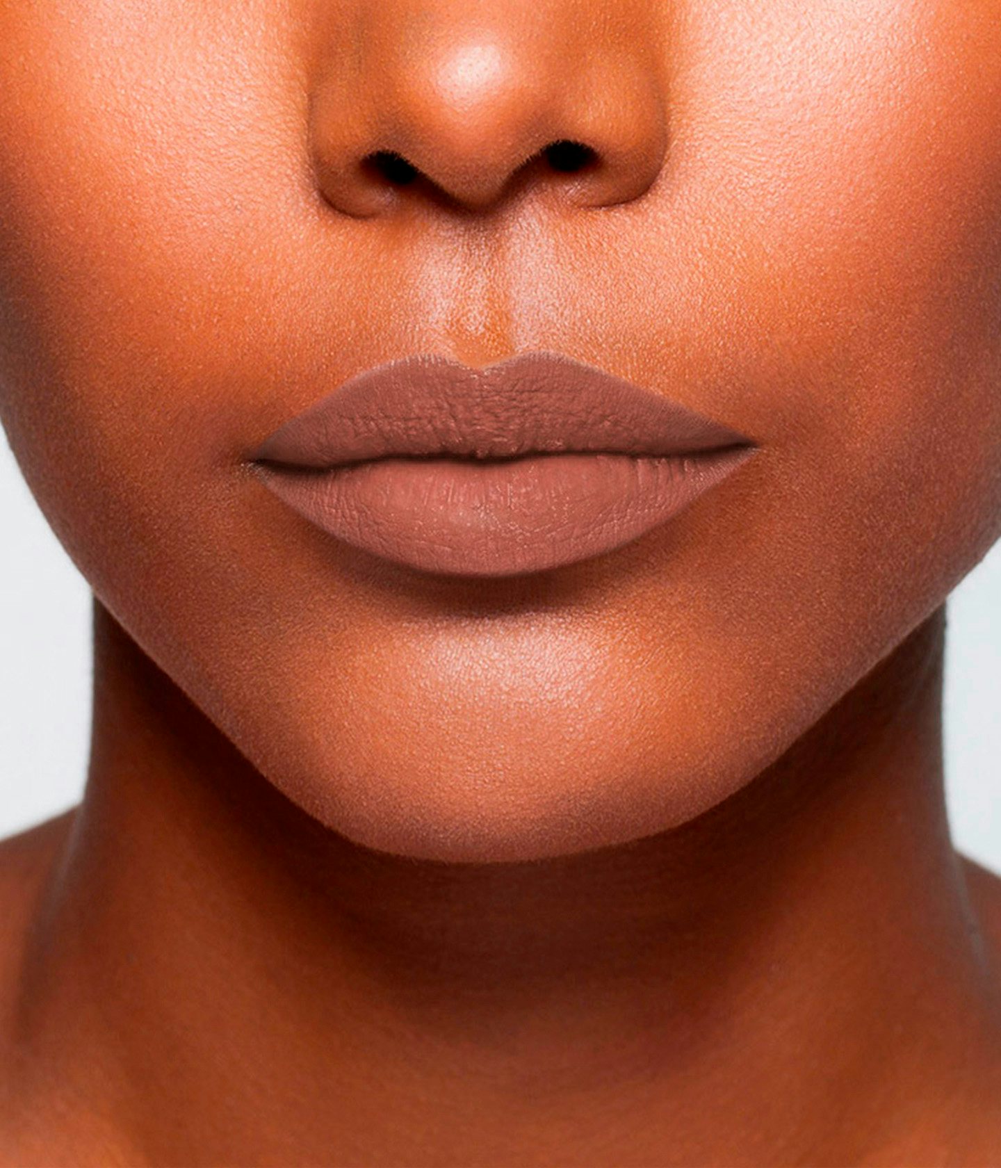 La bouche rouge Le Nude Monceau lipstick shade on the lips of a dark skin model