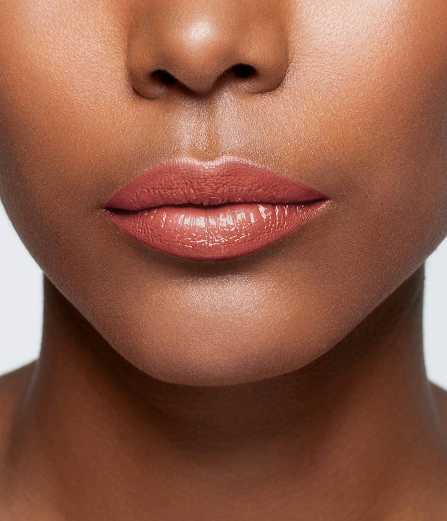 La bouche rouge Peach balm lipstick shade on the lips of a dark skin model