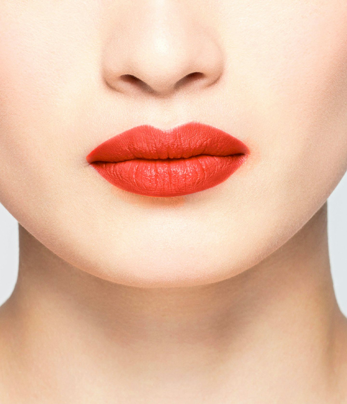 La bouche rouge Le Rouge Elsa lipstick shade on the lips of an Asian model