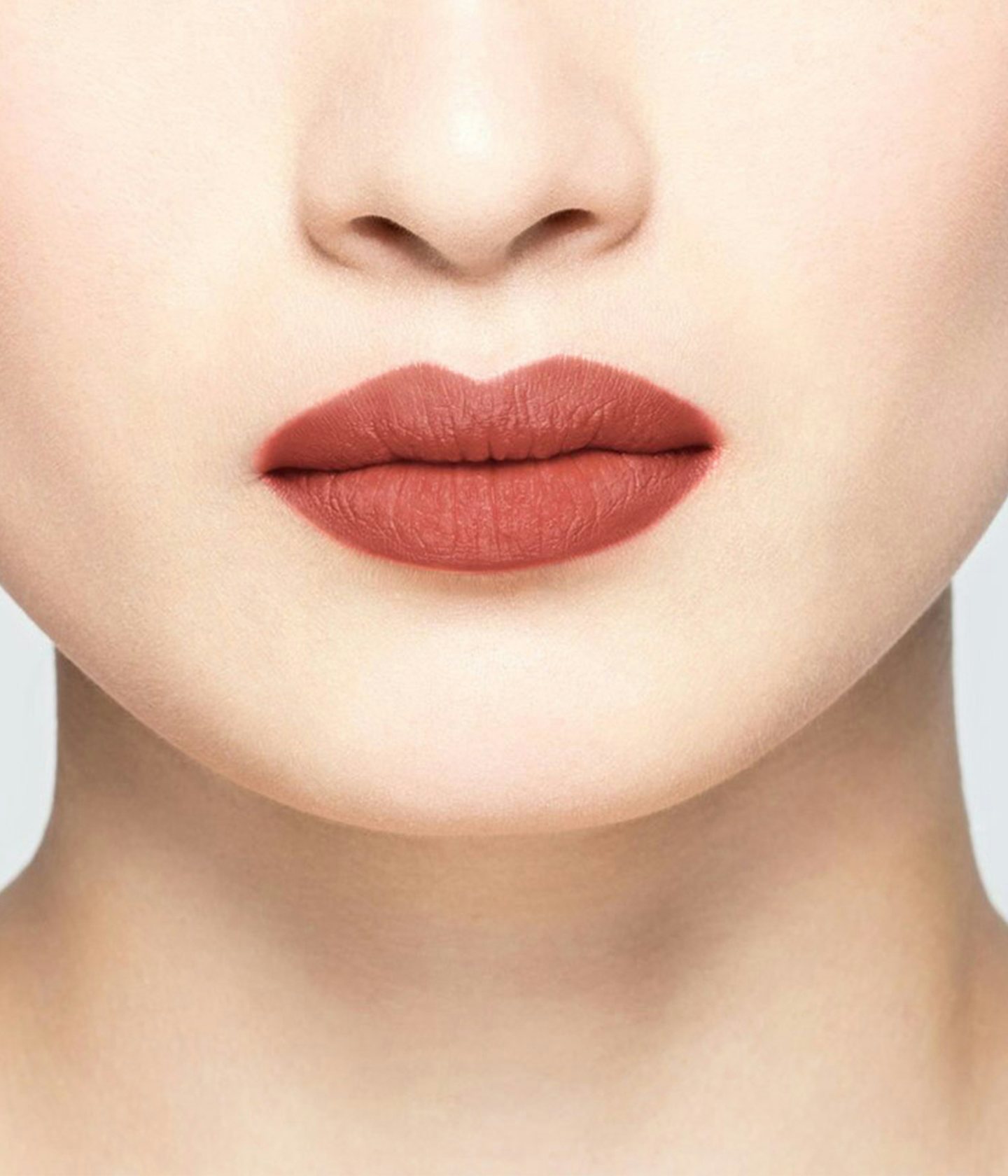 La bouche rouge Chestnut lipstick shade on the lips of an Asian model