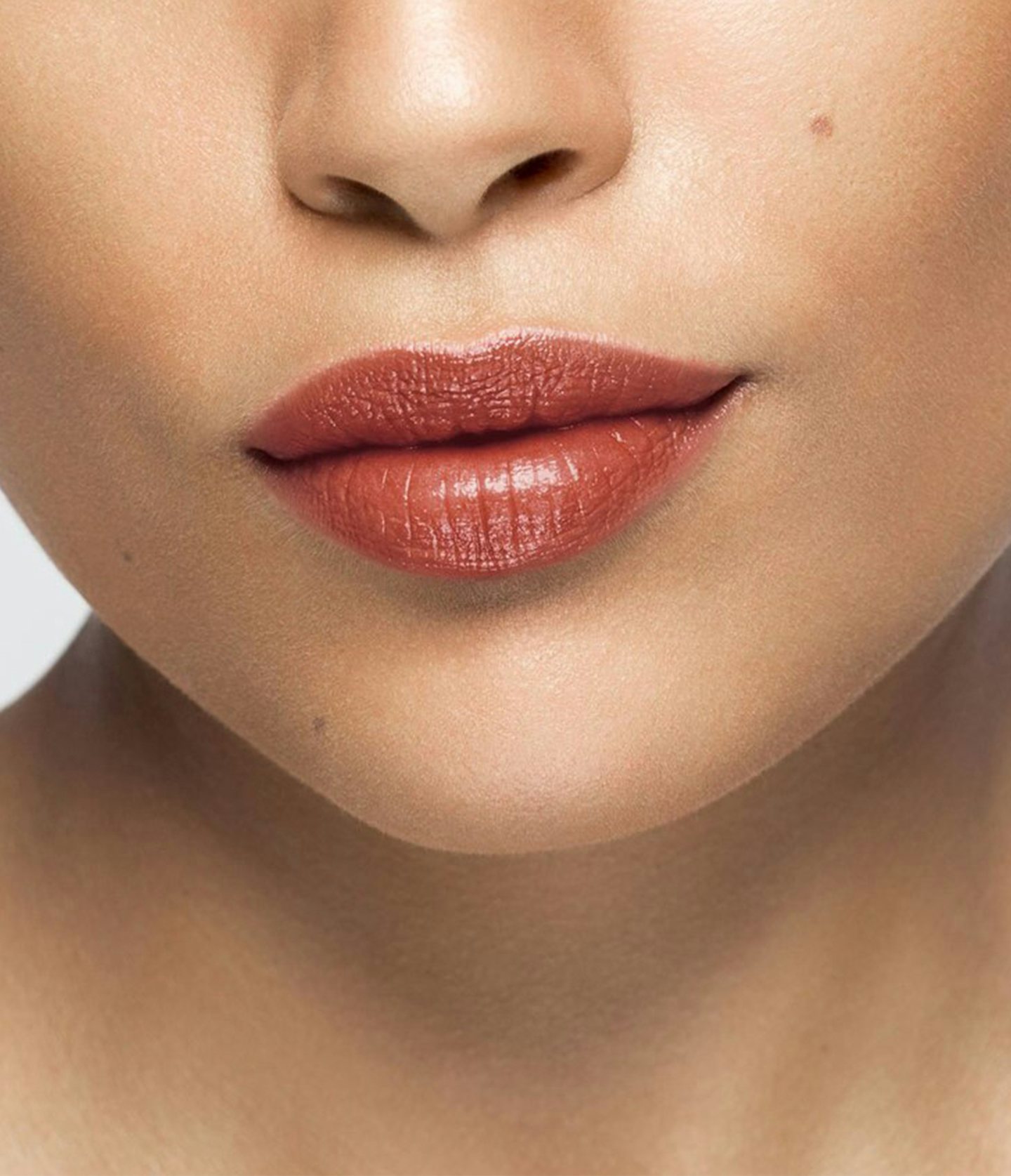 La bouche rouge Nude Red lipstick shade on the lips of an medium skin model