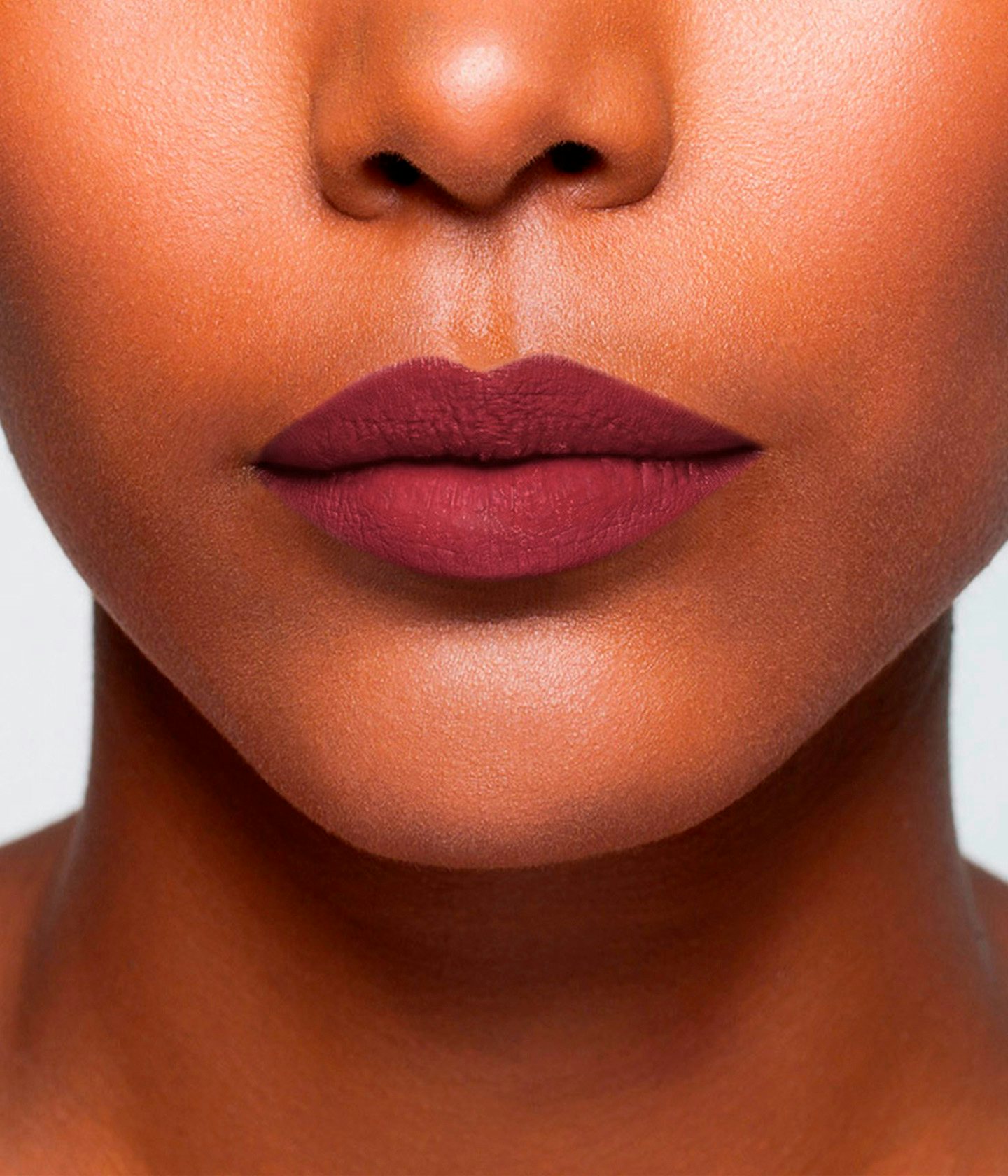 La bouche rouge Le Rose Tuileries lipstick shade on the lips of a dark skin model