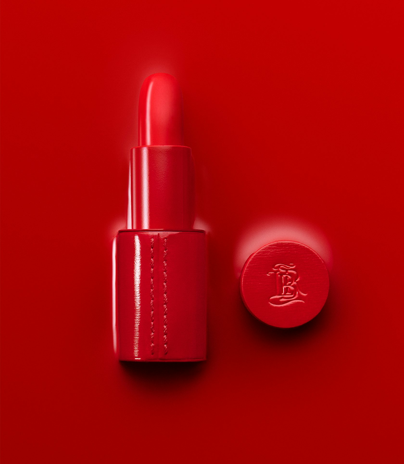 La bouche rouge red serum in red fine leather lipstick case on a red background