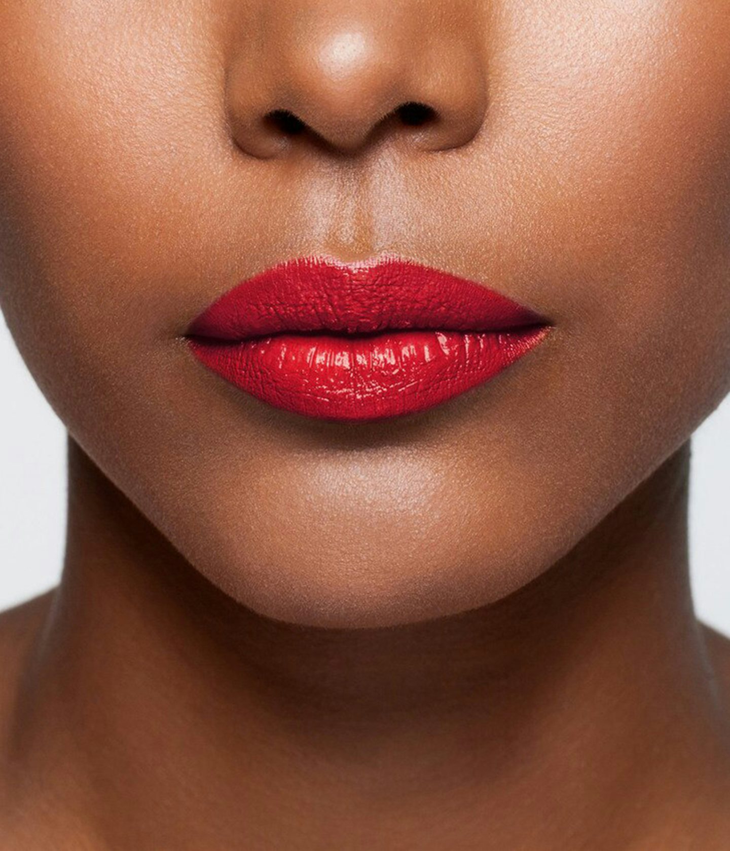 La bouche rouge Le Rouge Self Service Satin lipstick shade on the lips of a dark skin model