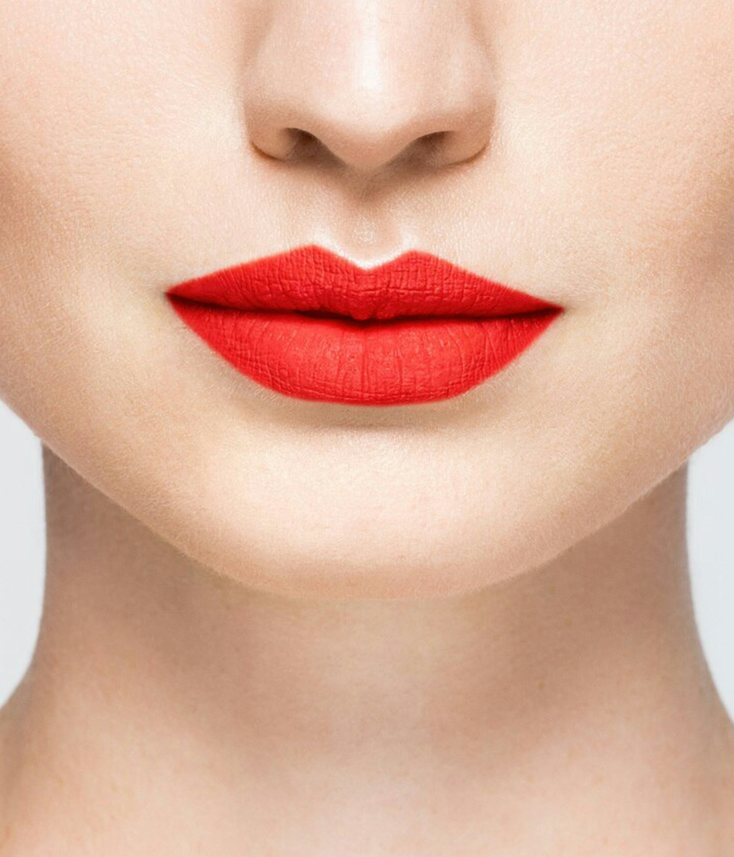 La bouche rouge Neon Gied lipstick shade on the lips of a fair skin model
