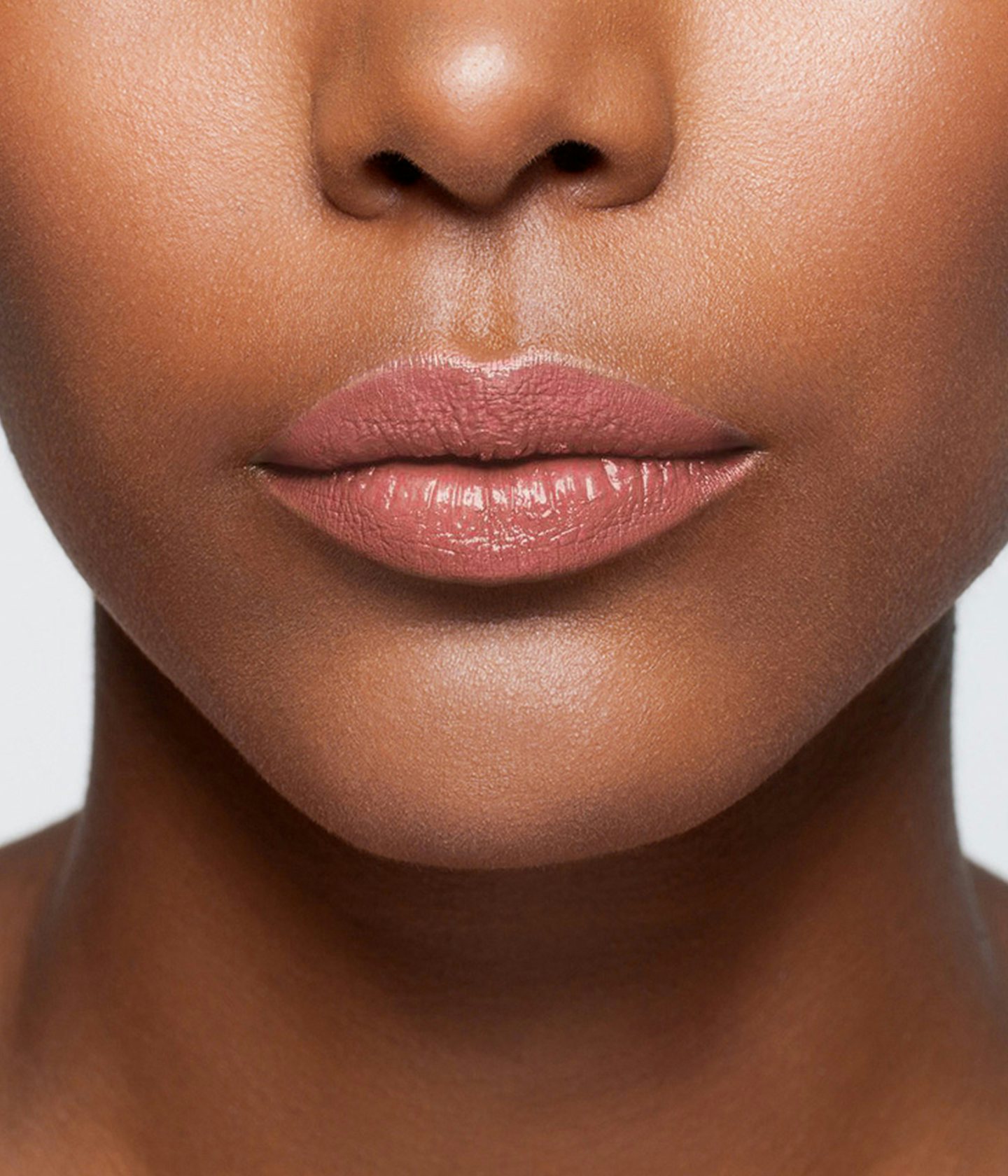 La bouche rouge Nude Brown lipstick shade on the lips of a dark skin model