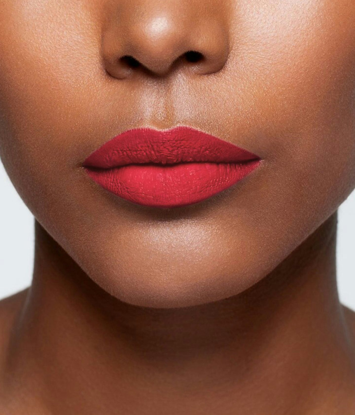 La bouche rouge Folie lipstick shade on the lips of a dark skin model