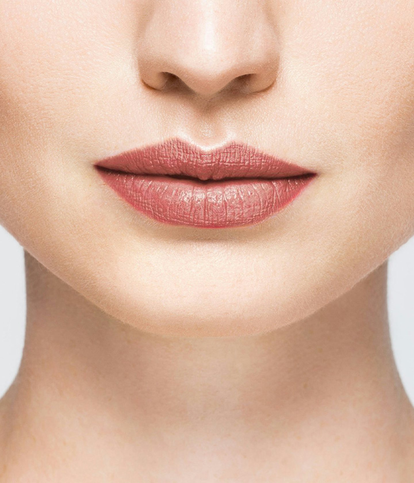 La bouche rouge Nude Brown lipstick shade on the lips of a fair skin model