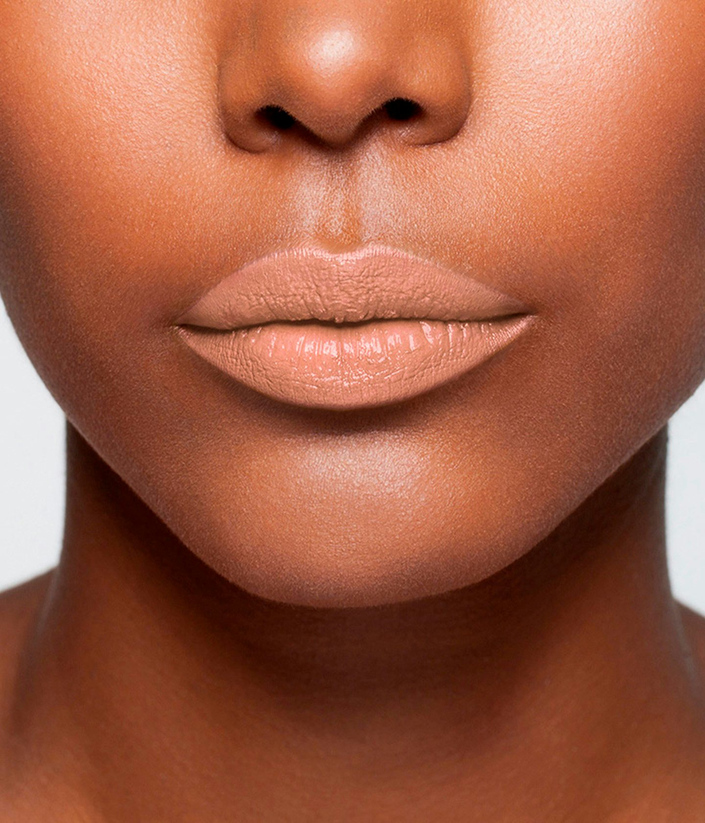 La bouche rouge Le Nude Veronika lipstick shade on the lips of a dark skin model