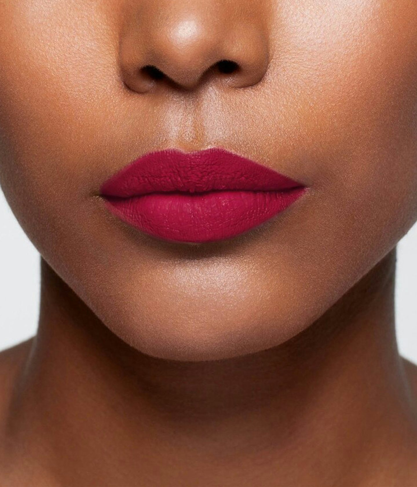 La bouche rouge Burgundy lipstick shade on the lips of a dark skin model