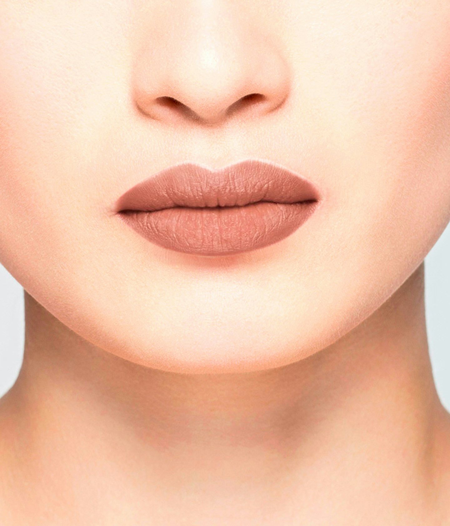 La bouche rouge Nude Brun Matte lipstick shade on the lips of an Asian model