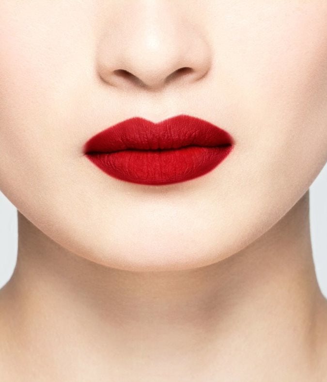 La bouche rouge Pop Art Red lipstick shade on the lips of an Asian model