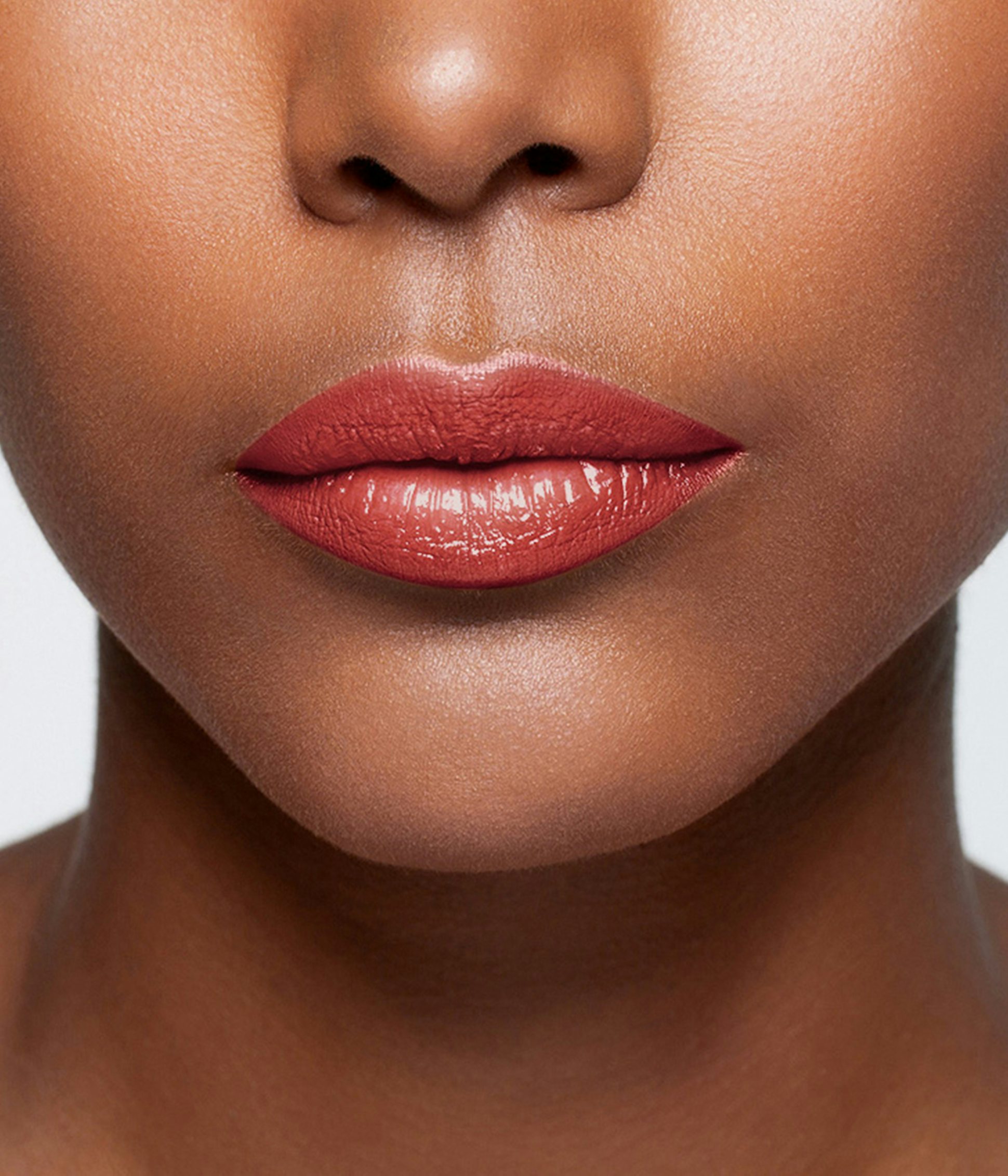 La bouche rouge Red balm lipstick shade on the lips of a dark skin model