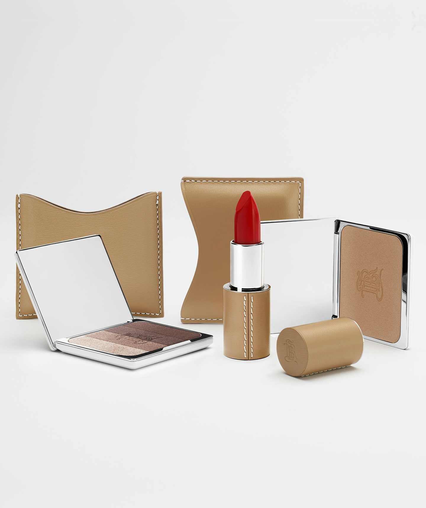 La bouche rouge lipstick, Les Ombres Aral eyeshadow and La Terre bronzer in camel fine leather cases